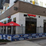 The outside of a Teriyaki Madness restaurant in Decatur, GA, as a corner view.